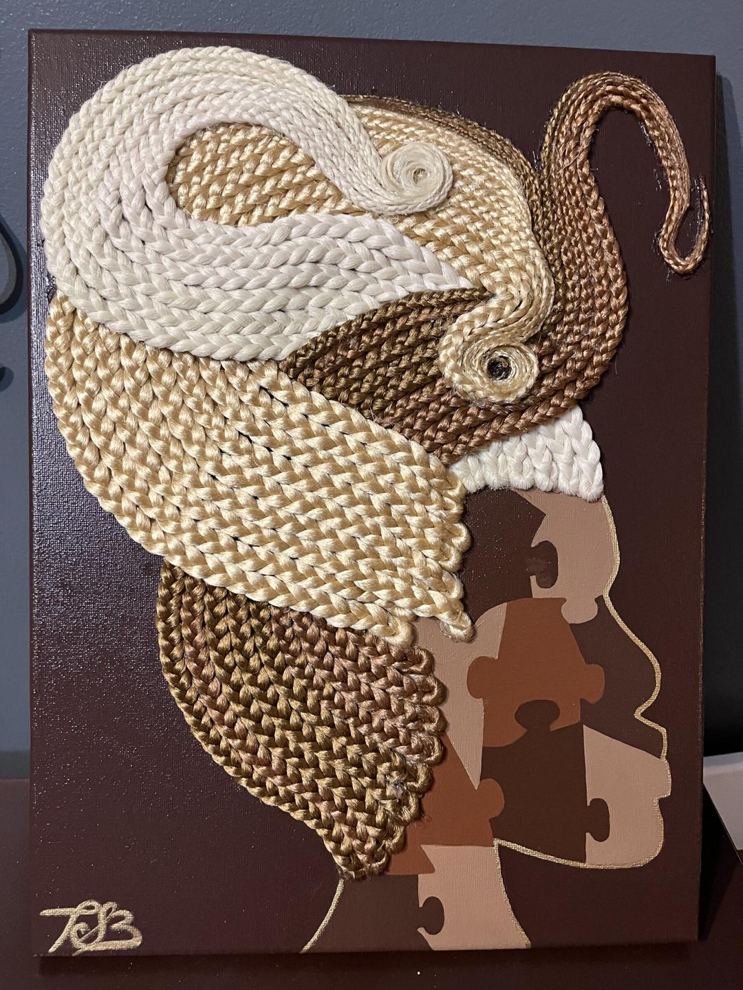 Profile of a woman on a deep brown canvas with cream, caramel and chocolate braids curling upward; her face is painted as puzzle pieces in warm browns.